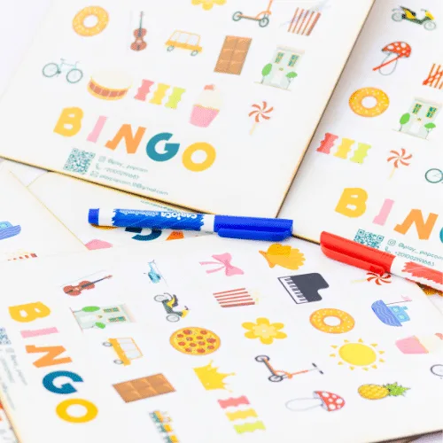 Several Bingo cards with colourful everyday shapes spread on a table