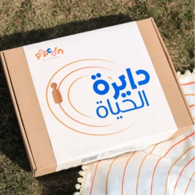 Circle of Life game box resting on its round play mat on the grass