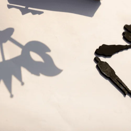 The shadow of a Khayal puppet shape cast on a light wall